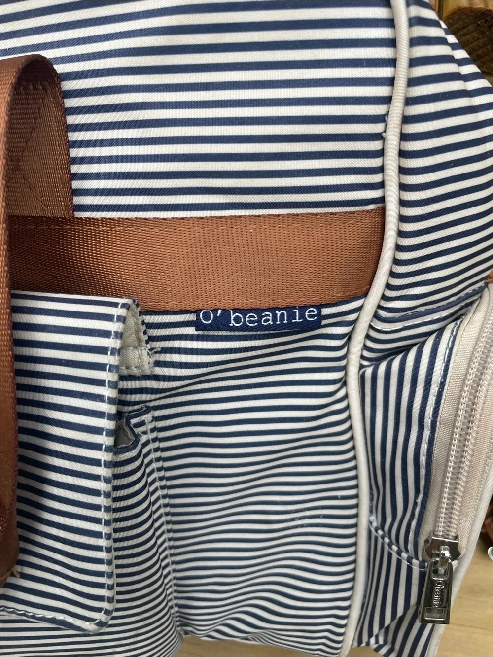 O' Beanie White and Navy Striped Diaper Bag. Brown straps with shoulder pad.